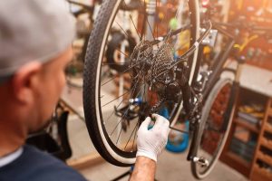 mechanic repairing bicycle in his workshop